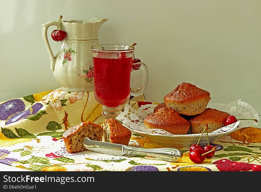 Muffins, cold drink and cherry