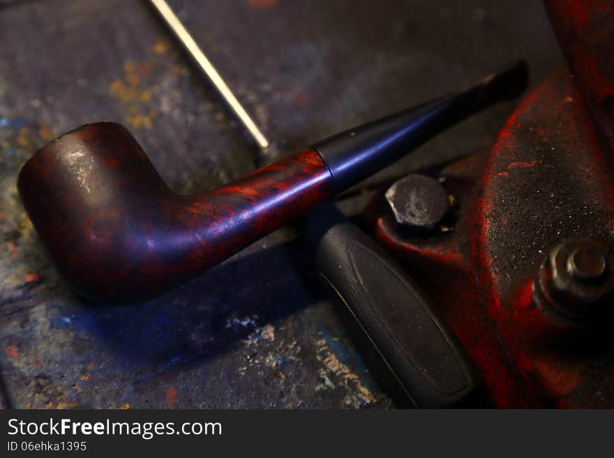 Old brown pipe on workbench