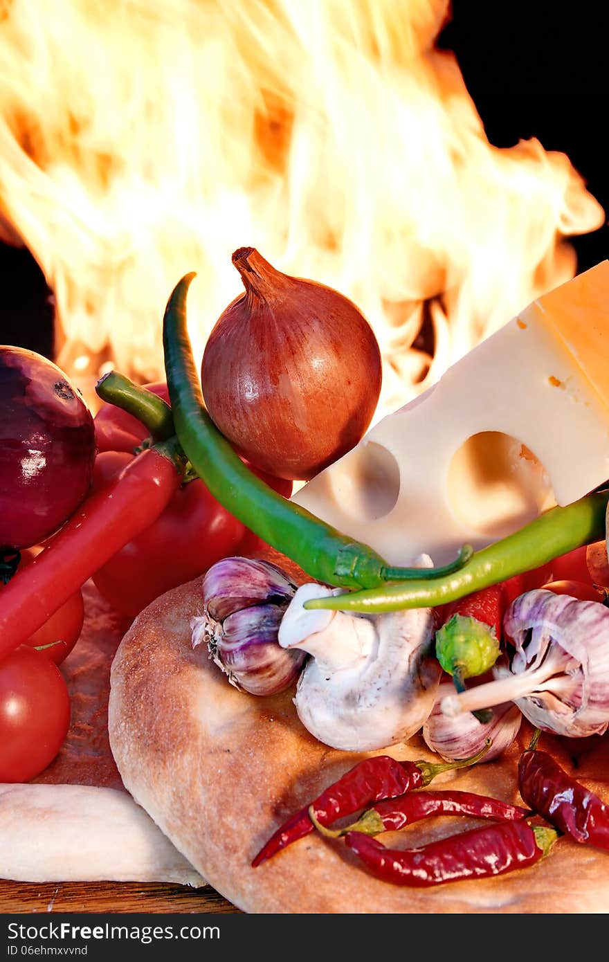 Fresh Bread and Vegetables on a Wooden Panel front of an Open fireplace. Fresh Bread and Vegetables on a Wooden Panel front of an Open fireplace