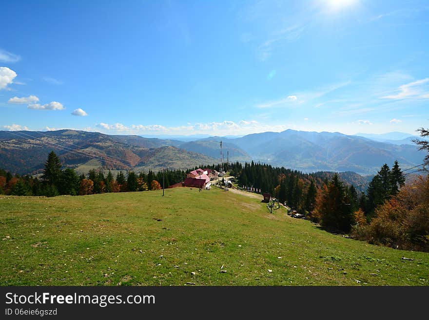 Autumn Landscape With Cottage And Mountains