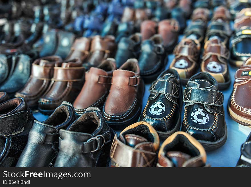 Rows of kids shoes at a swap meet