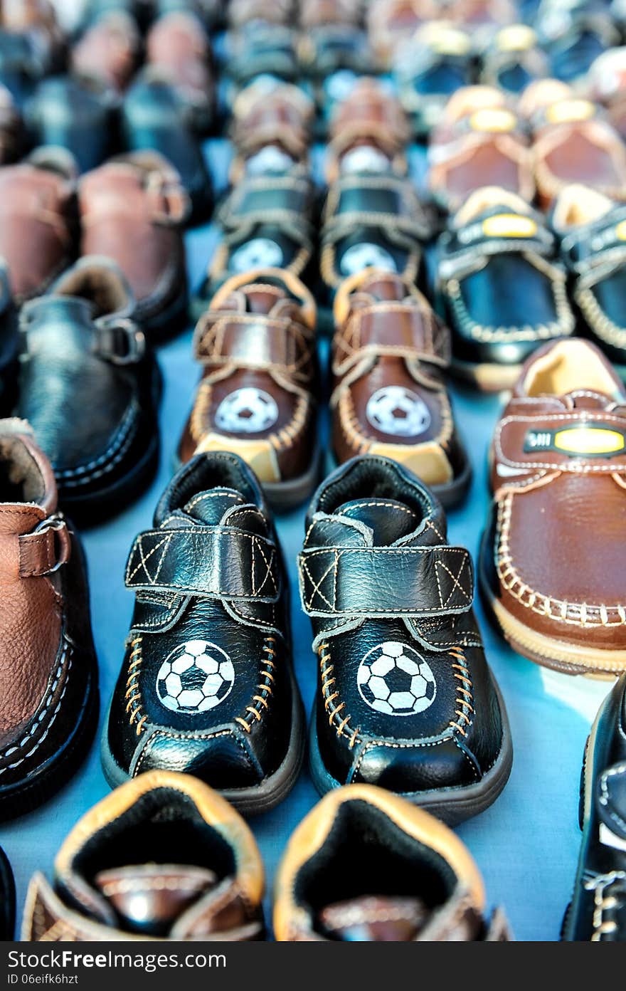 Rows of kids shoes at a swap meet