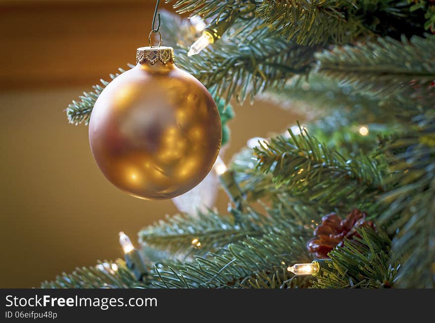 A lone Christmas ball hanging from the tree. A lone Christmas ball hanging from the tree.