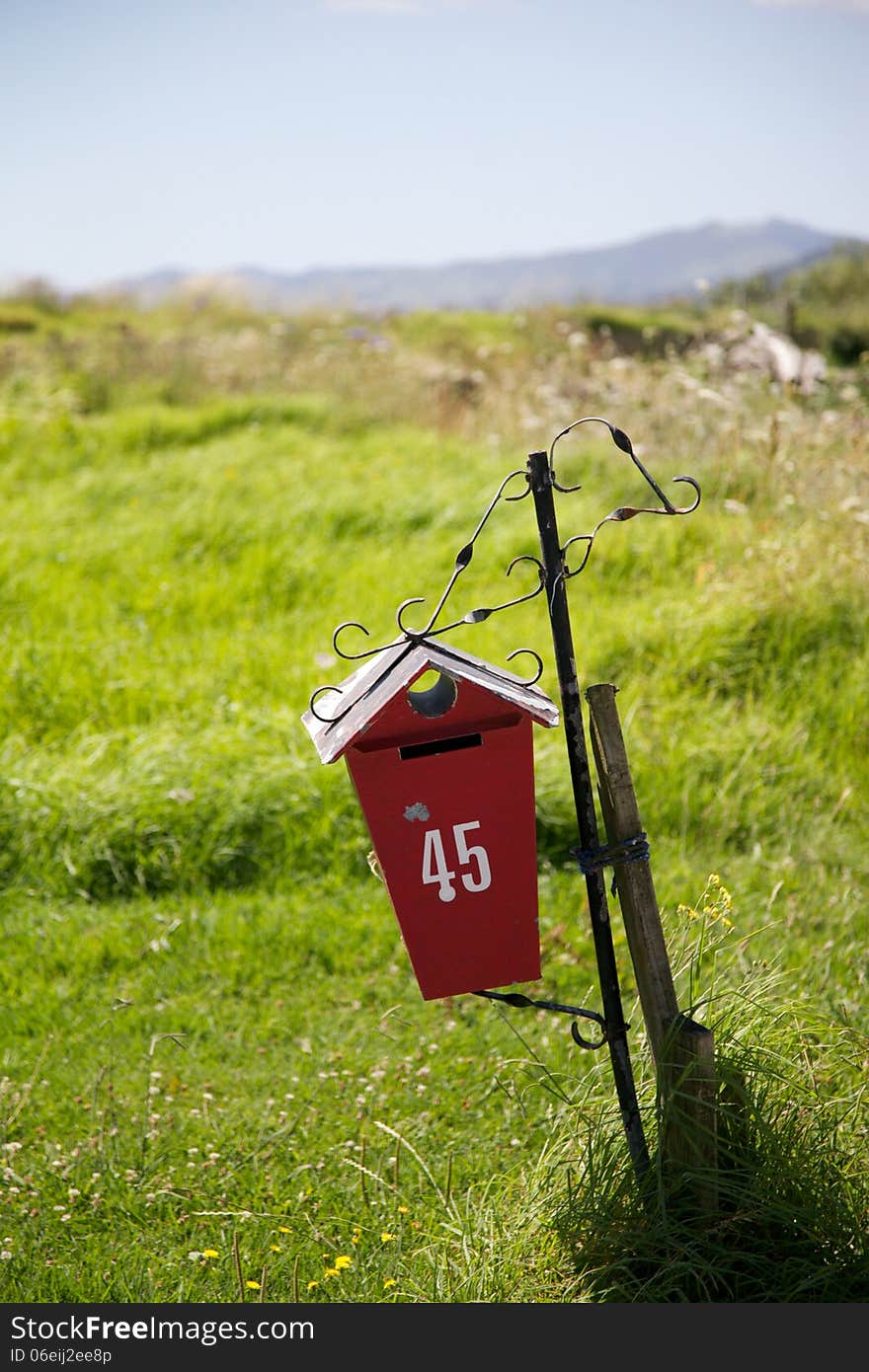 Bright red letter box - NZ farming image.