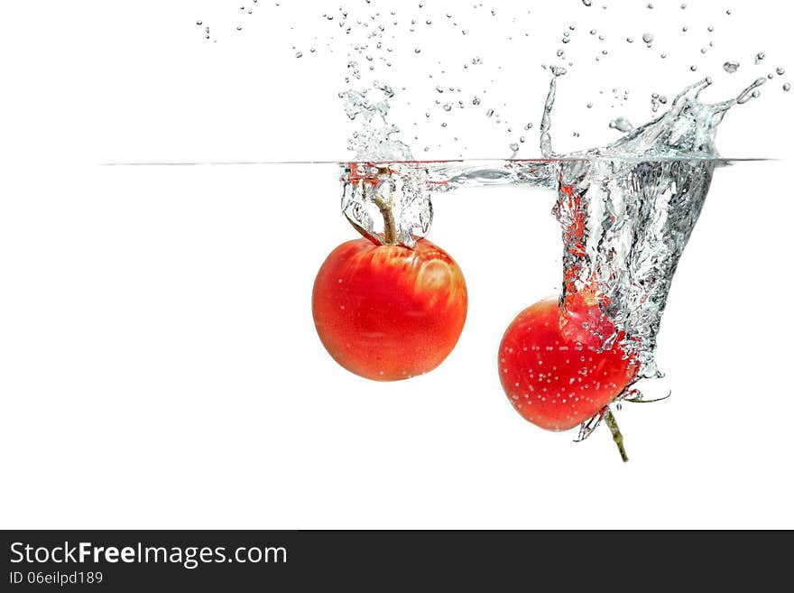 Fresh tomatoes falling into the water. Fresh tomatoes falling into the water