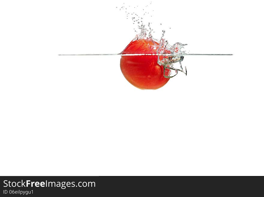 Fresh tomatoes falling into the water. Fresh tomatoes falling into the water