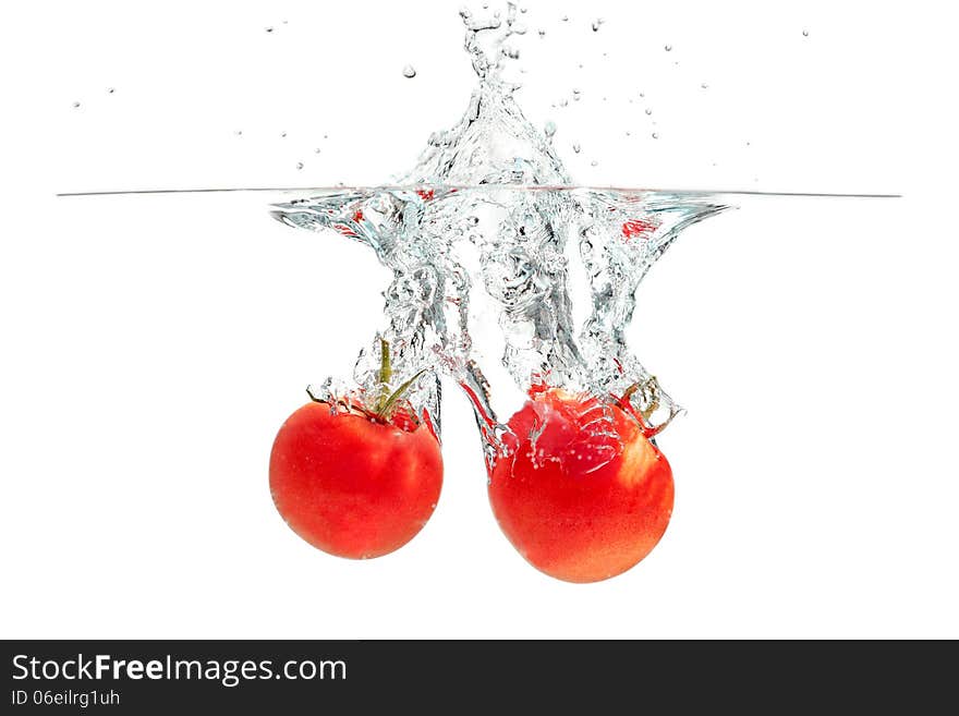 Fresh tomatoes falling into the water. Fresh tomatoes falling into the water