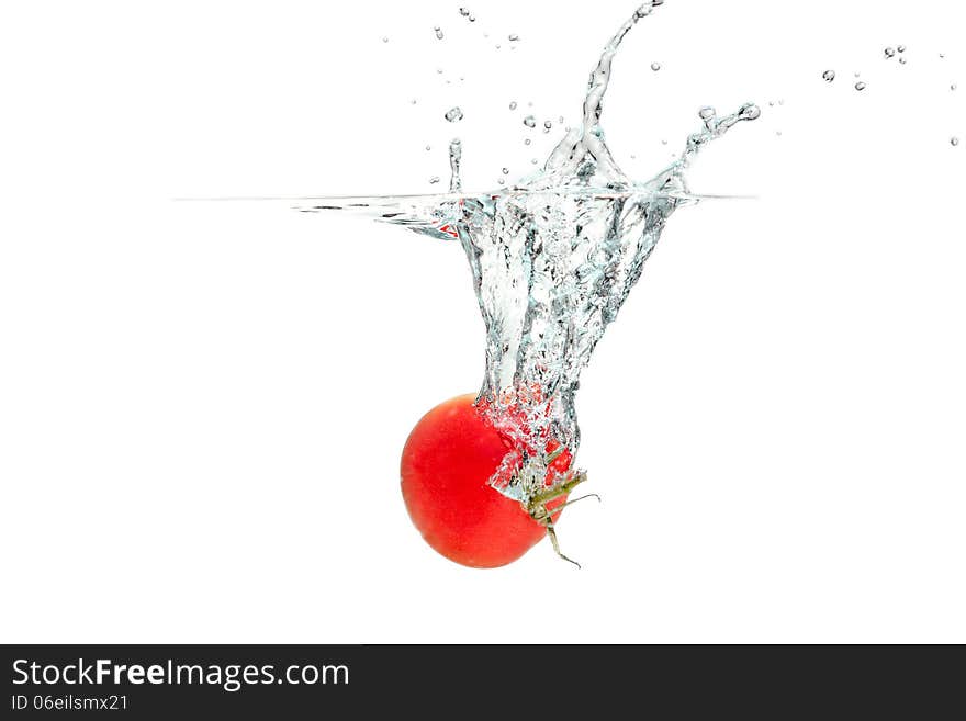 Fresh tomatoes falling into the water. Fresh tomatoes falling into the water