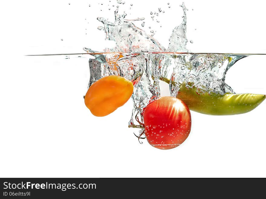 Fresh tomatoes falling into the water. Fresh tomatoes falling into the water