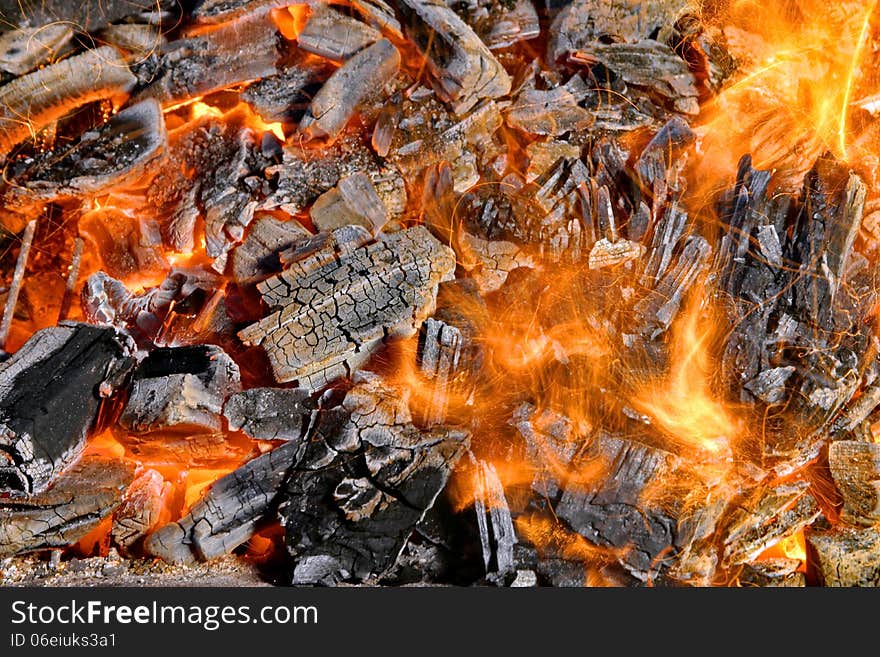 Wind blowing on burning coal in a barbecue and a flame with flying sparks. Wind blowing on burning coal in a barbecue and a flame with flying sparks