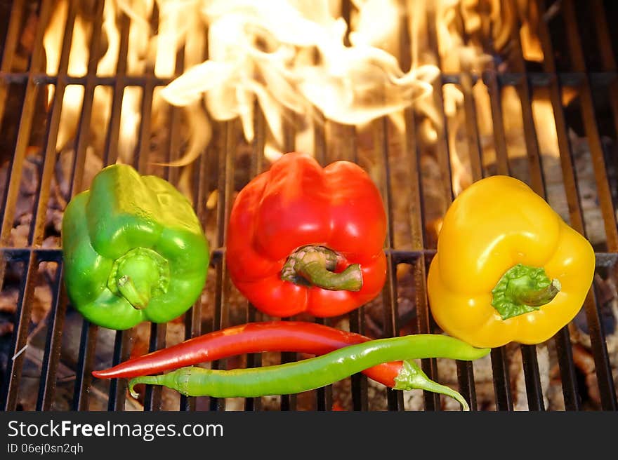 Colorful Bell & Chile peppers on the hot BBQ cast iron grill. Colorful Bell & Chile peppers on the hot BBQ cast iron grill