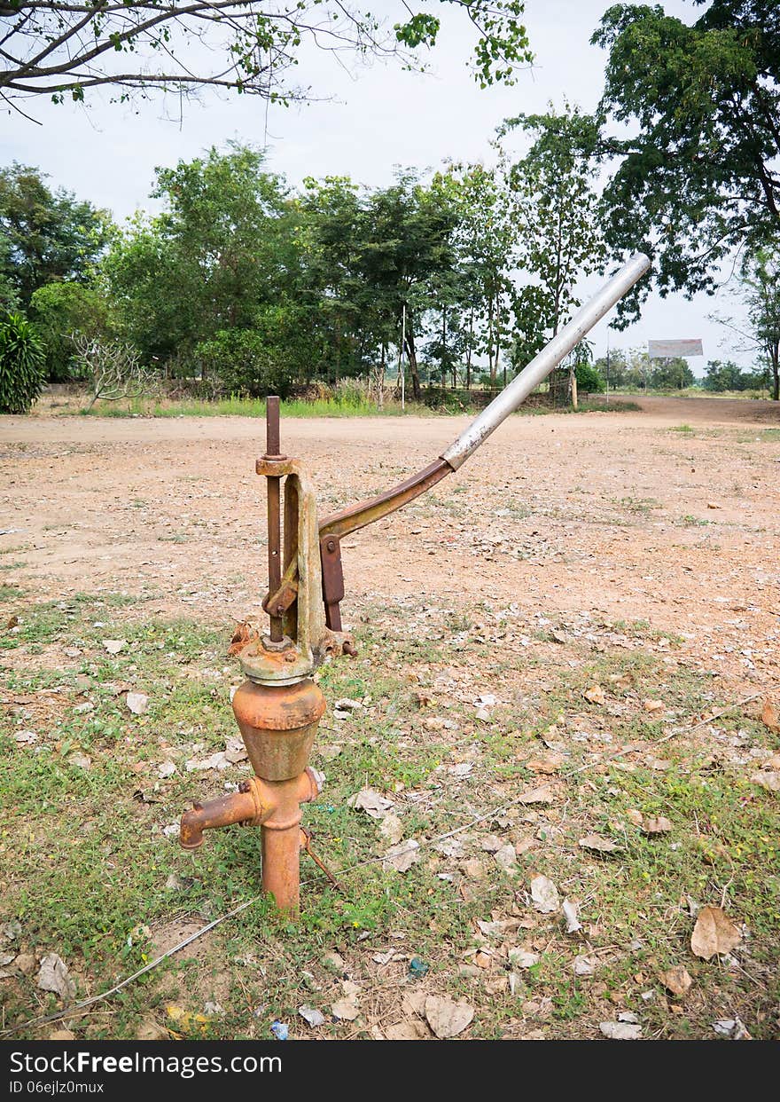 Old rusty iron water hand pump. Old rusty iron water hand pump