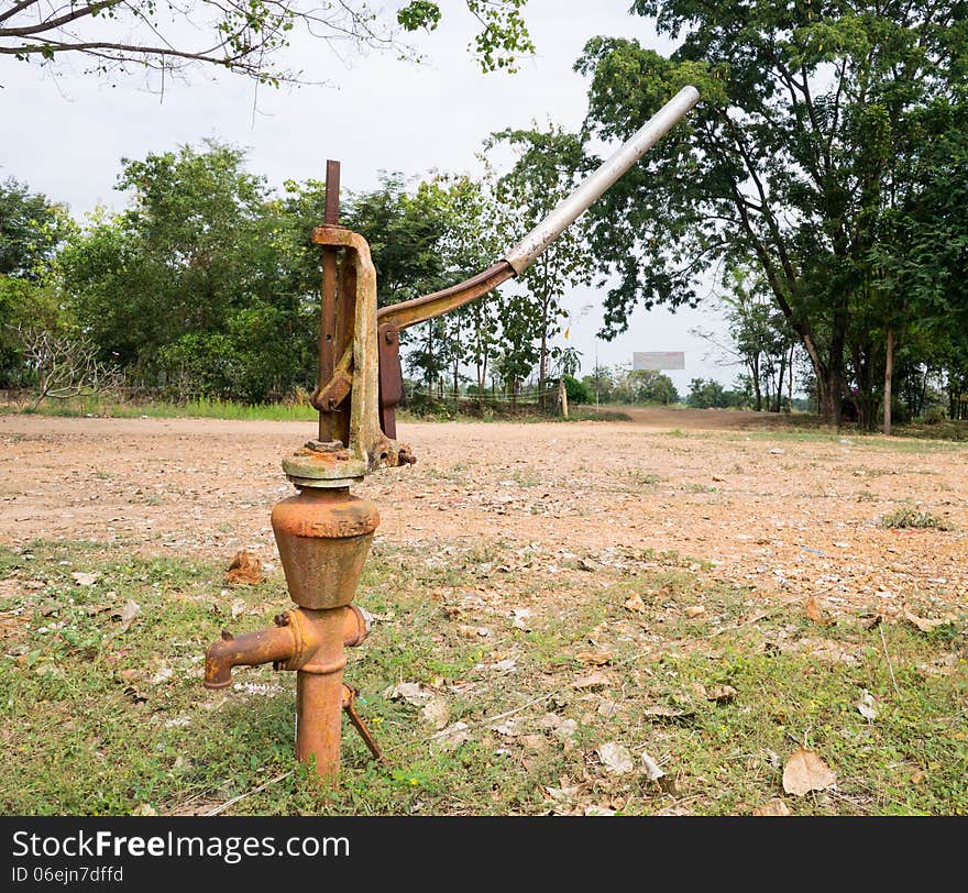 Old rusty iron water hand pump. Old rusty iron water hand pump