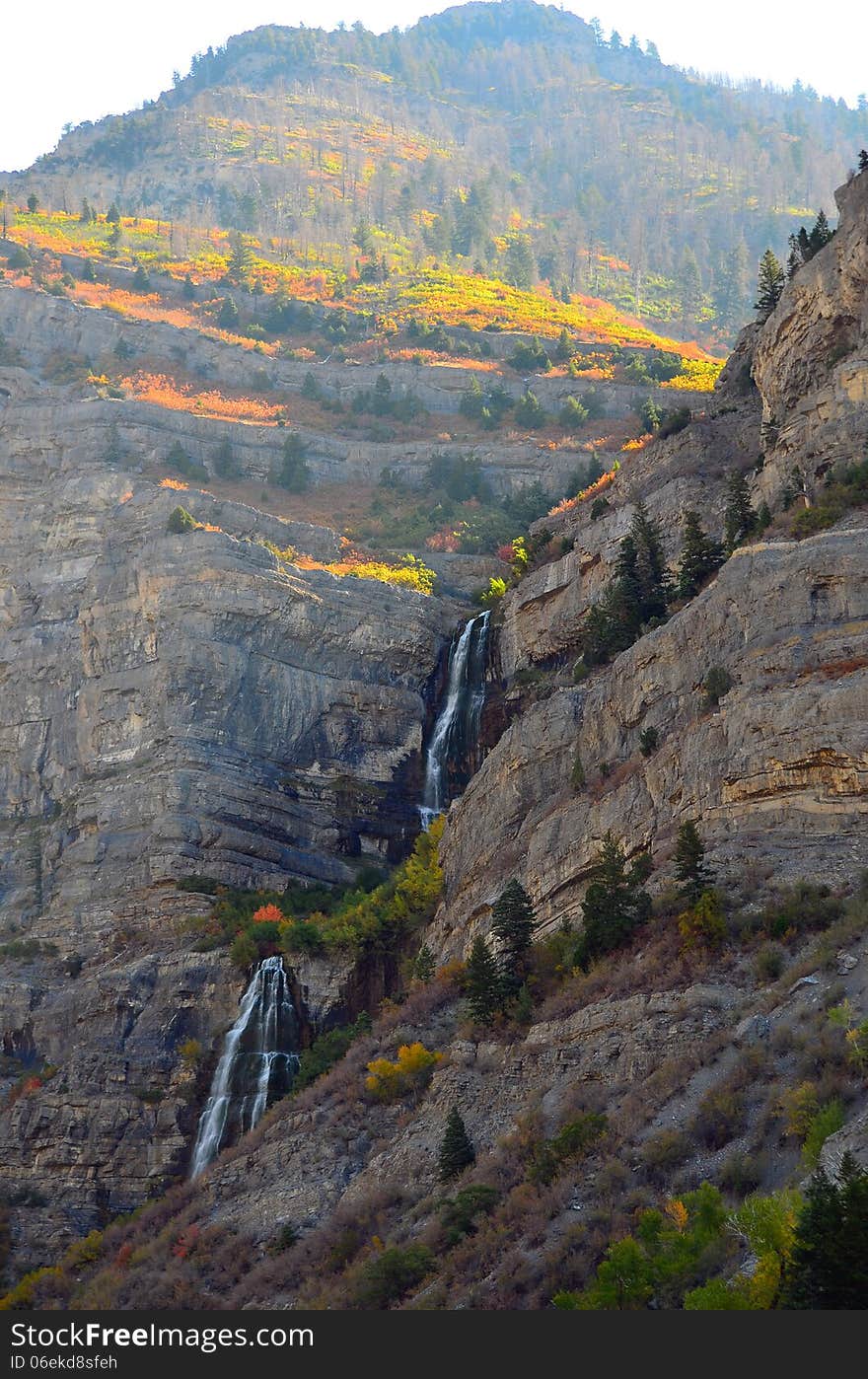 Fall colors crest waterfalls in a mountain scene near Provo, Utah. Fall colors crest waterfalls in a mountain scene near Provo, Utah.