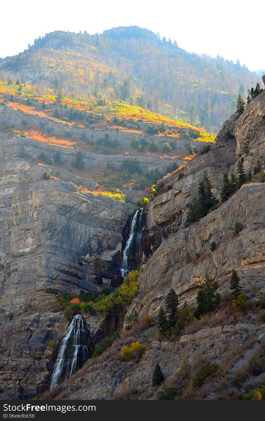 Fall colors crest waterfalls in a mountain scene near Provo, Utah. Fall colors crest waterfalls in a mountain scene near Provo, Utah.