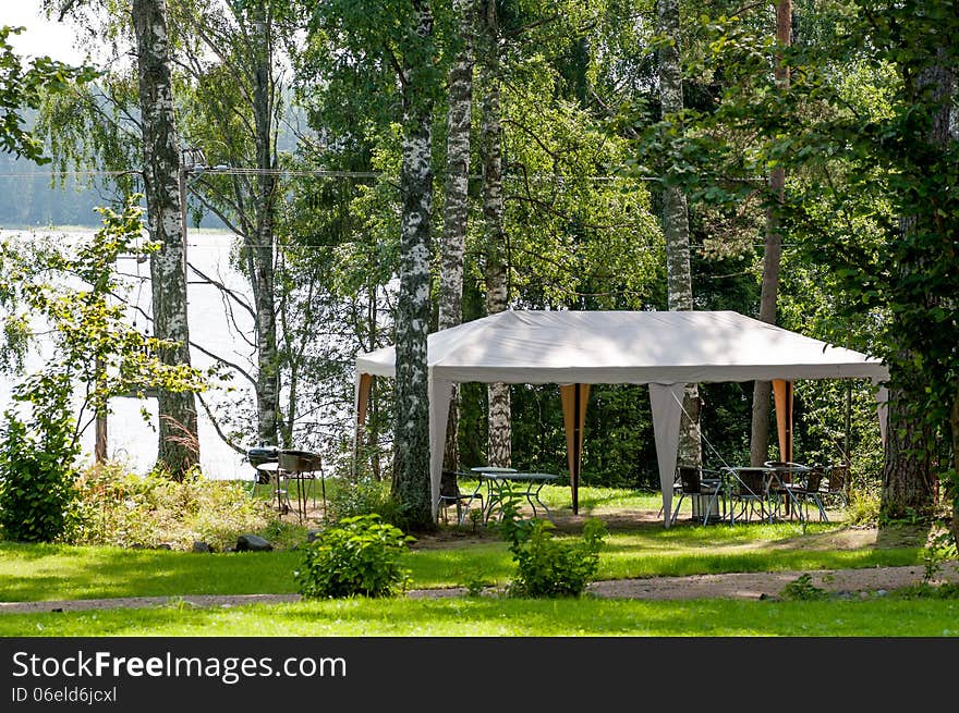 Resting place for barbecue in the forest on the shore of lake