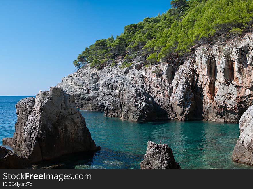 Rocky bay with green mediterranean vegetation