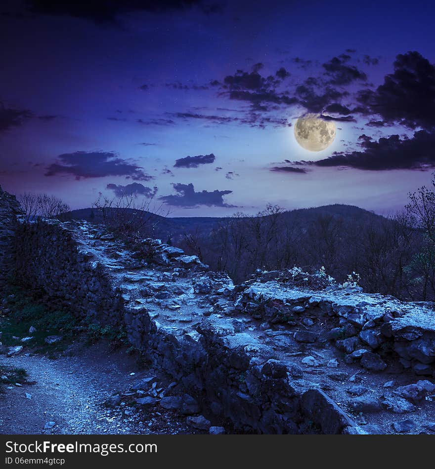 Ruins of an old castle in the mountains at night