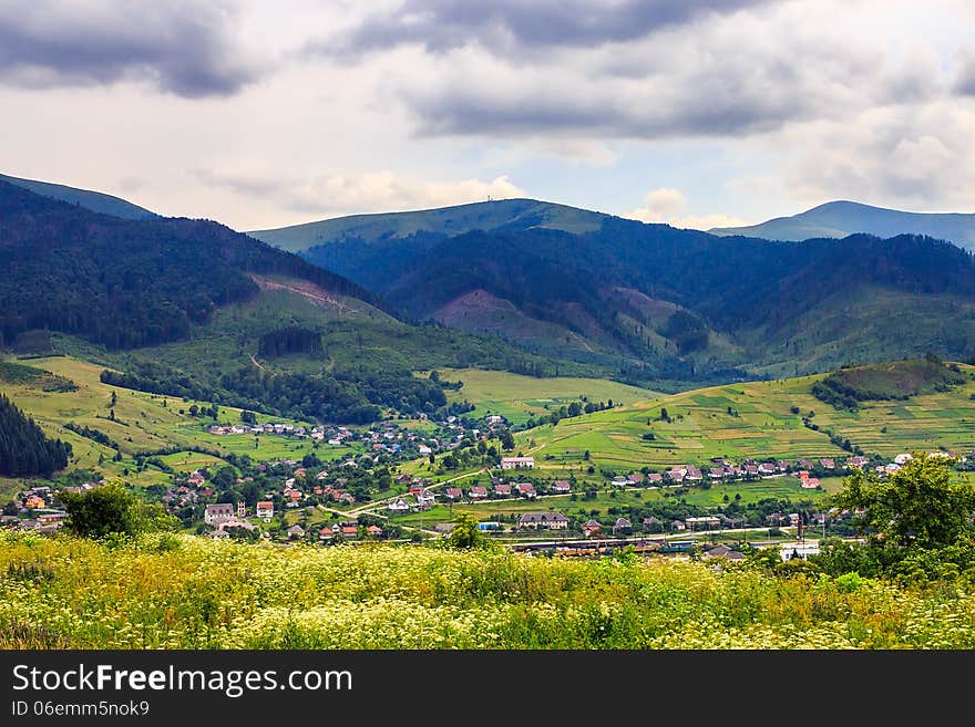 Light  beam falls on hillside with autumn village in mountain