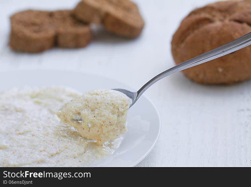 Porridge oats with spoon and bread, healthy breakfast