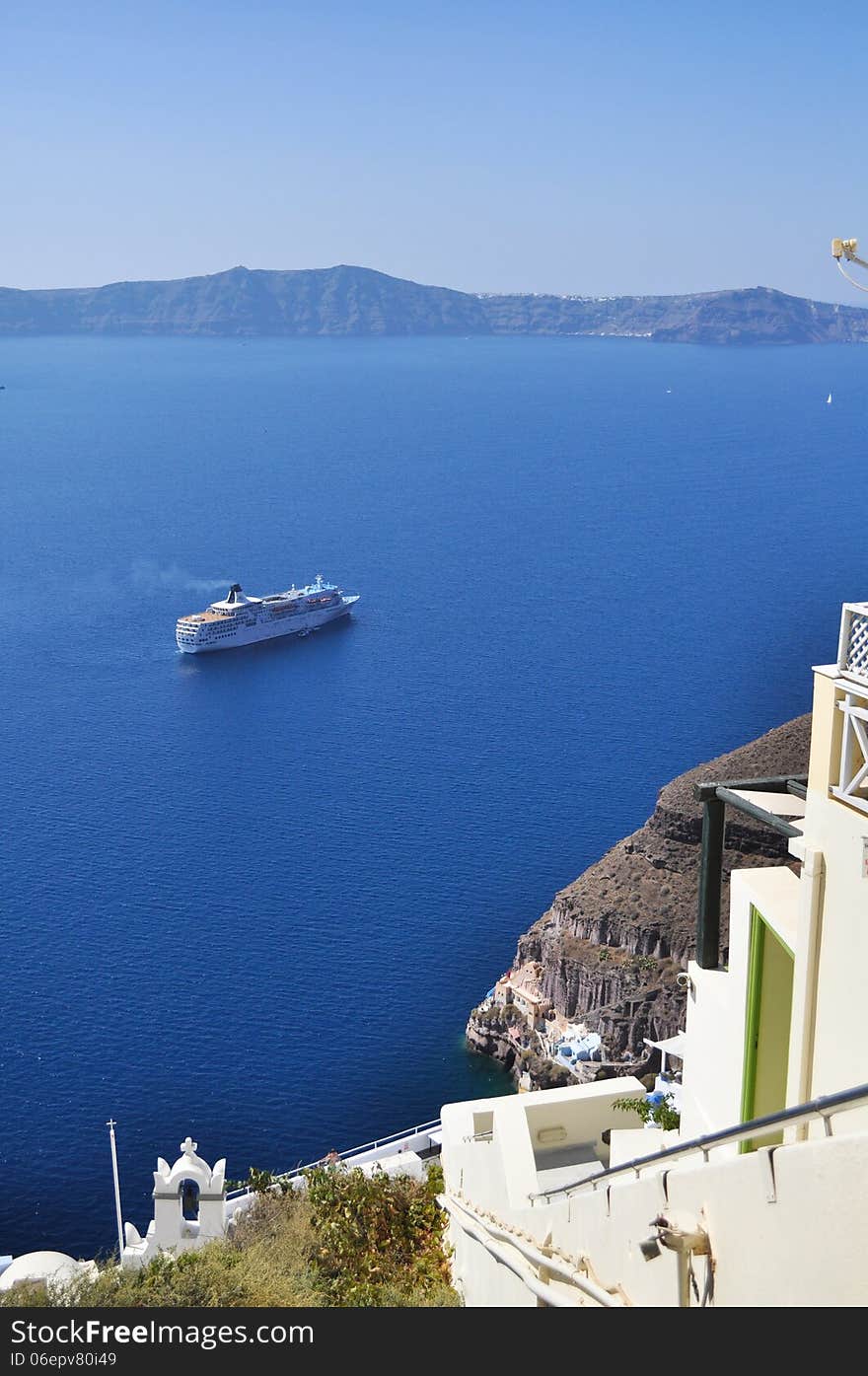 Ship in the Aegean sea near the rocks on the shore of the island