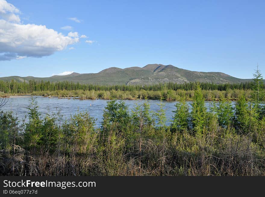 Water summer landscape surrounding the river Suntar in the Highlands of Oymyakon, Yakutia, Russia. Water summer landscape surrounding the river Suntar in the Highlands of Oymyakon, Yakutia, Russia.