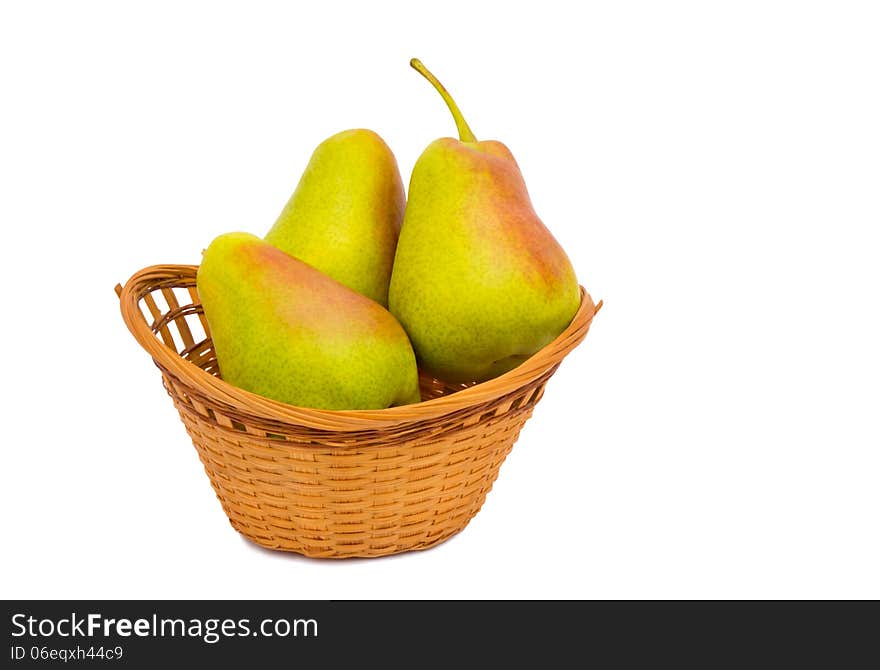 Large ripe pears in a wicker basket on a white background.