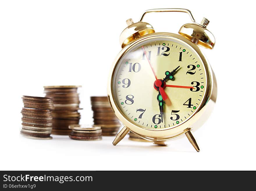 Alarm Clock And Coins In Pile