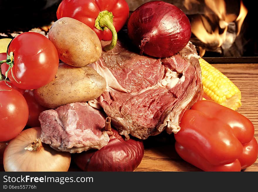 Fresh steak and vegetables at the open fireplace