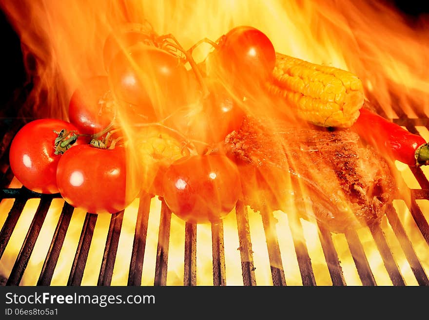 Grilled Rib Steak And Vegetables In The Flames Of  BBQ