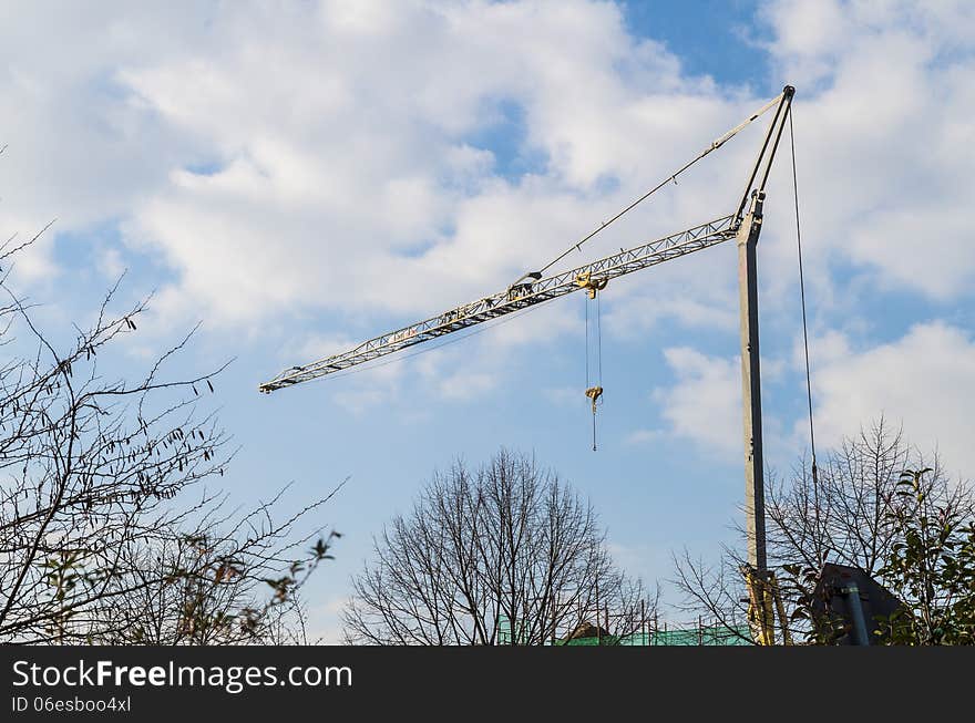 Building cranes on blue sky and clouds