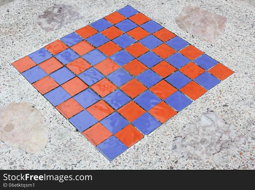 Square checkers on a marble table.