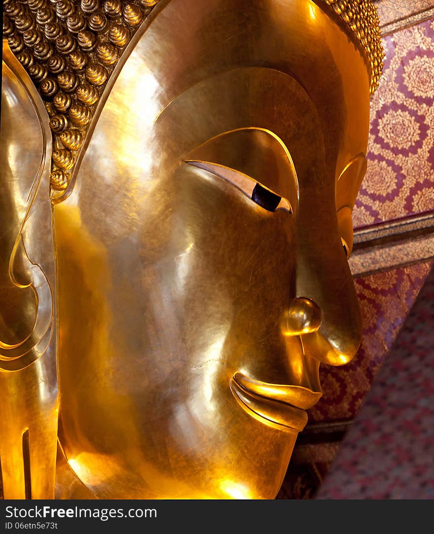 The Face of Big golden Reclining Buddha at Wat Pho in Bangkok, Thailand. The image of reclining Buddha is 15 m high and 43 m long. The Face of Big golden Reclining Buddha at Wat Pho in Bangkok, Thailand. The image of reclining Buddha is 15 m high and 43 m long.