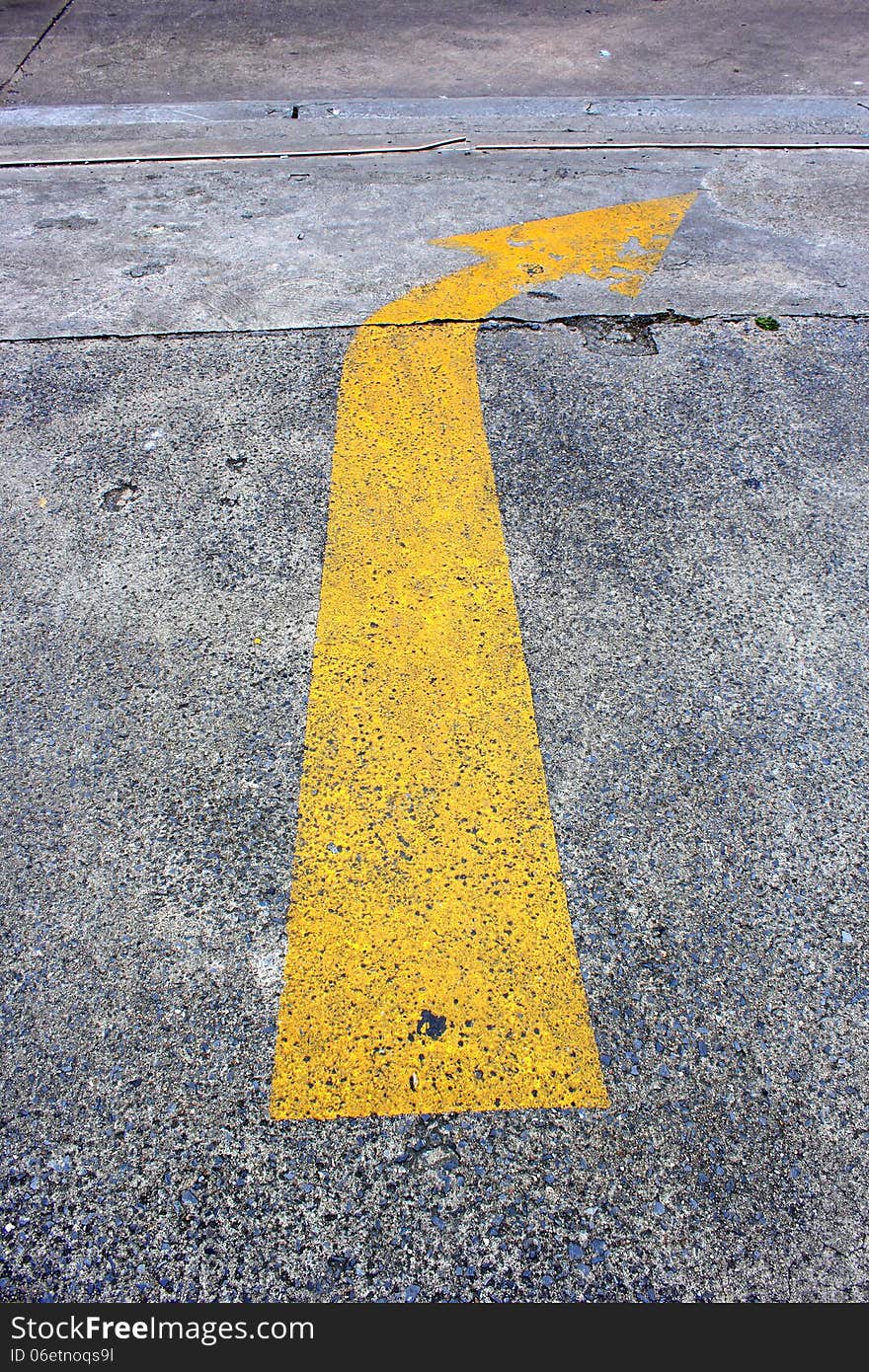 Close up yellow Arrow traffic on the road