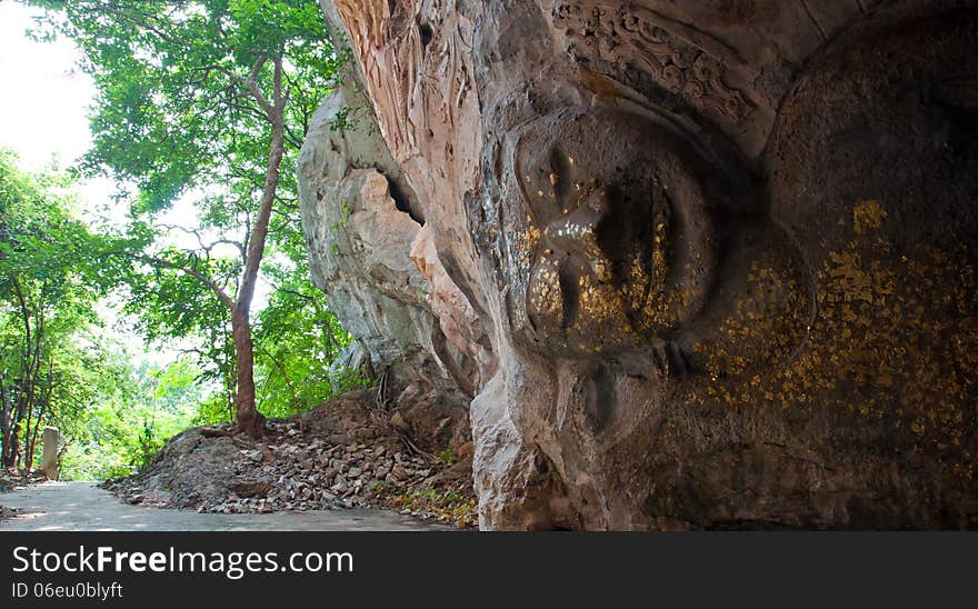 The Stucco Of Ancient Reclining Buddha At The Khao Ngu Cave In T