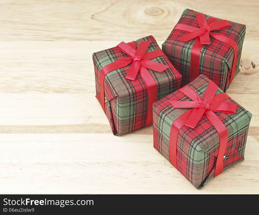 Three of red gift box decorate on wood background. Three of red gift box decorate on wood background