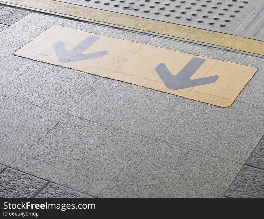 Dual arrow sign on edge sky train platform. Dual arrow sign on edge sky train platform