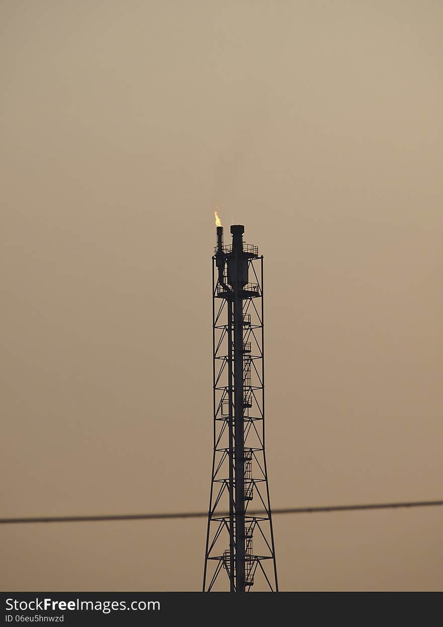 High tower distillation of refinery in evening sky