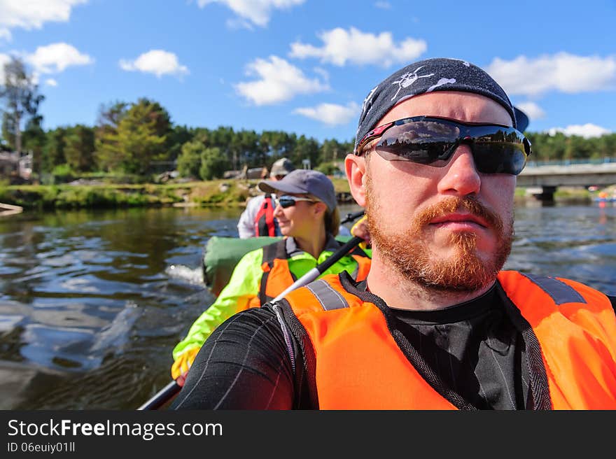 Severe men and cheerful women Kayaking in the Karelia