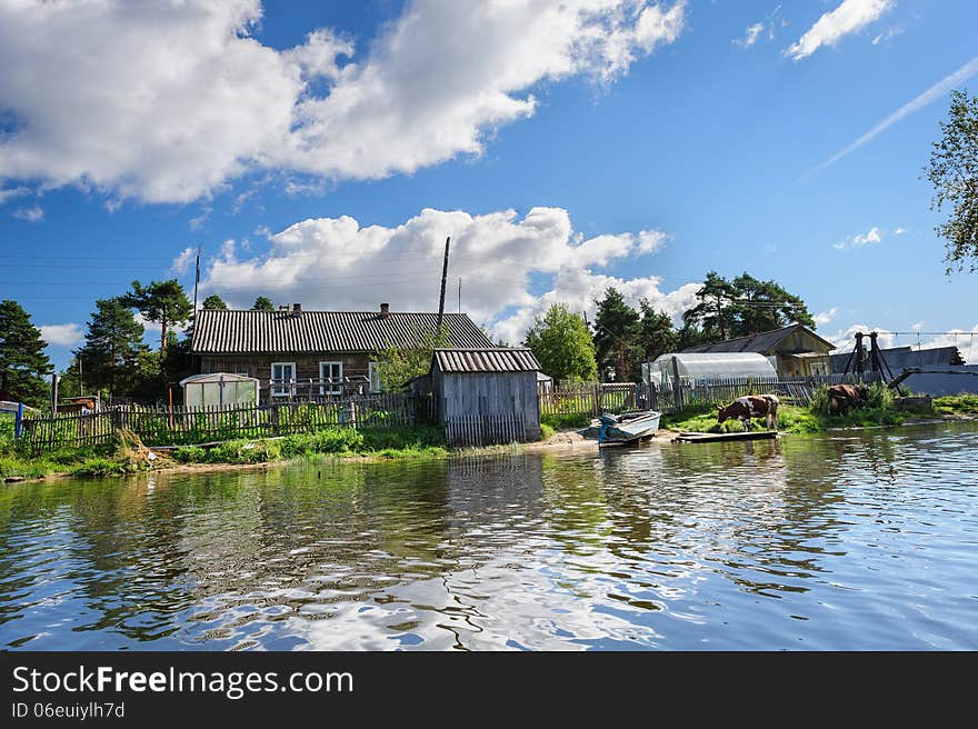 Russian Wooden Houses At River Bank