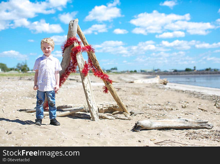 Little boy with tinsel wrapped around him for Christmas. Little boy with tinsel wrapped around him for Christmas.