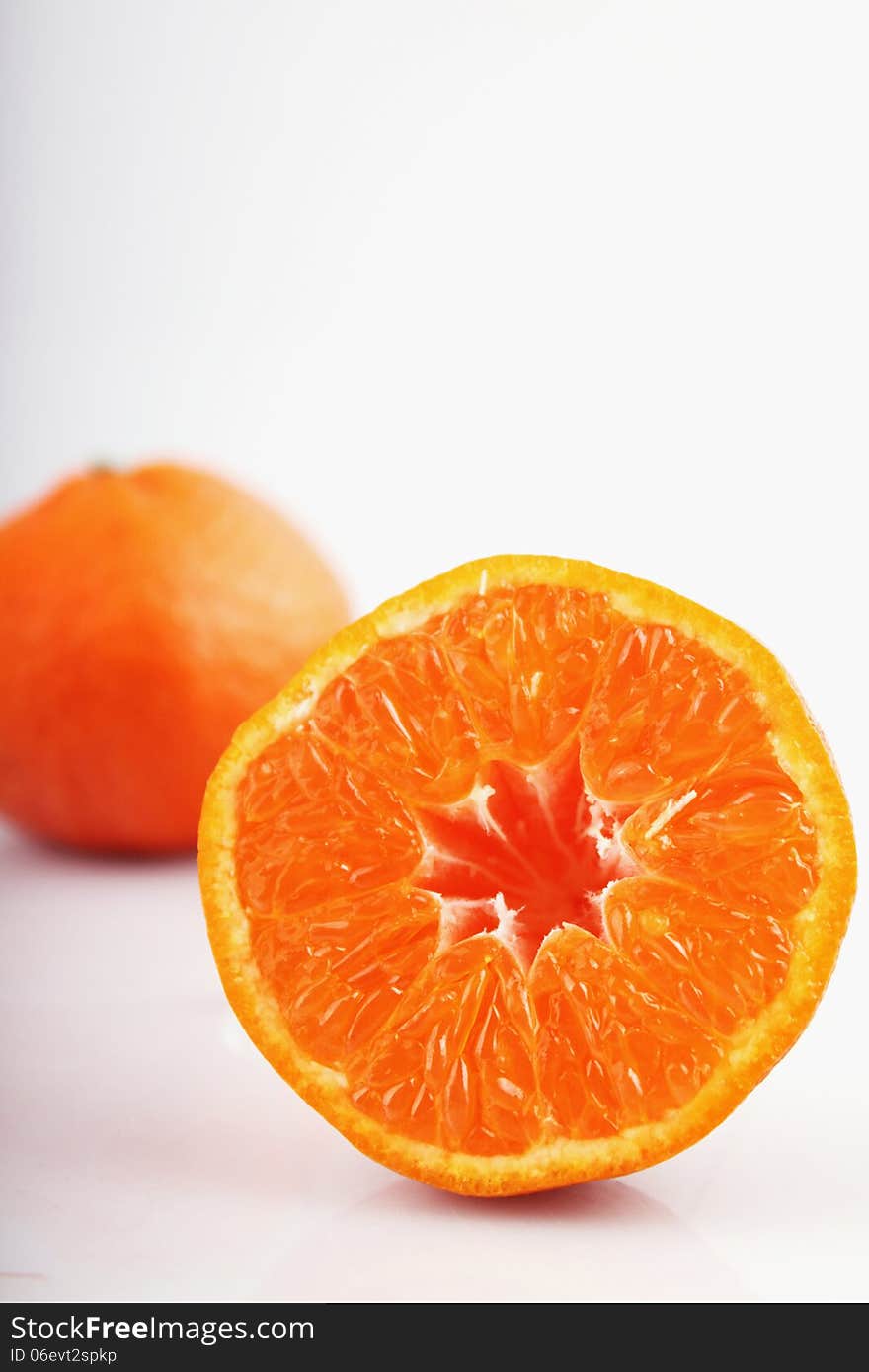 Peeled orange on the white background