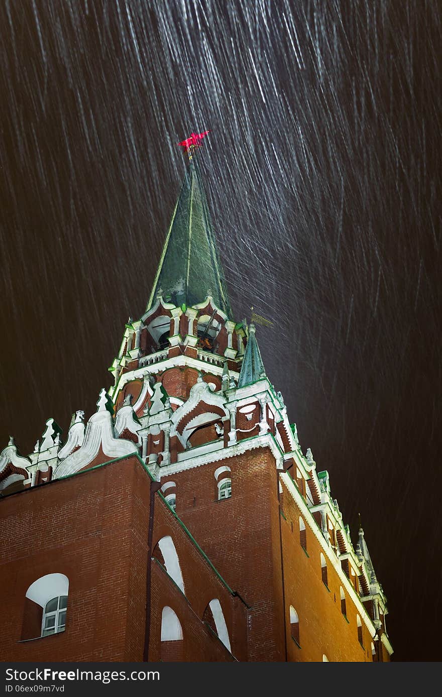 Night snowstorm in Moscow. Trinity Tower - the tallest of the 20 towers that surround the Moscow Kremlin. Russia.