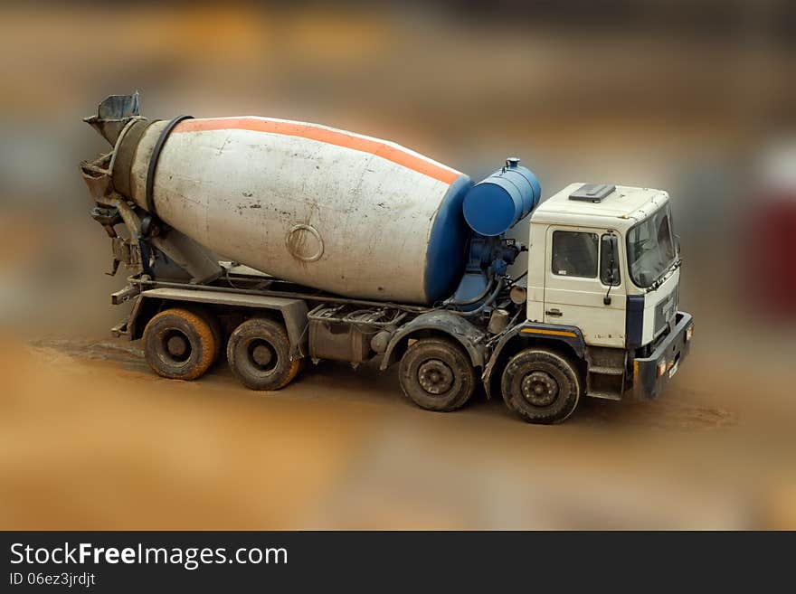 Concrete Mixer Truck on blurred background, close up. Concrete Mixer Truck on blurred background, close up.