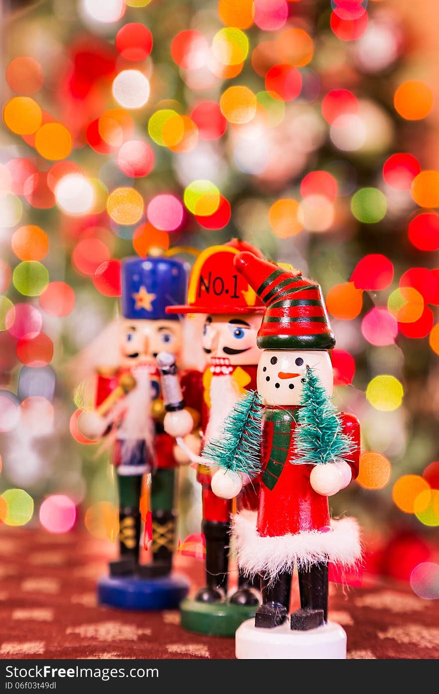 Three christmas figures on the tree background