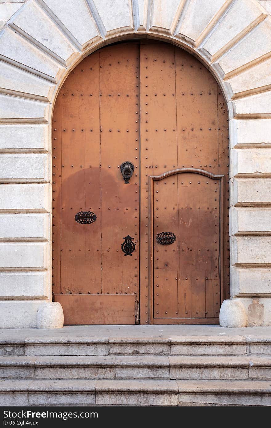 Nice arch metal door of ancient church with staircase. Nice arch metal door of ancient church with staircase