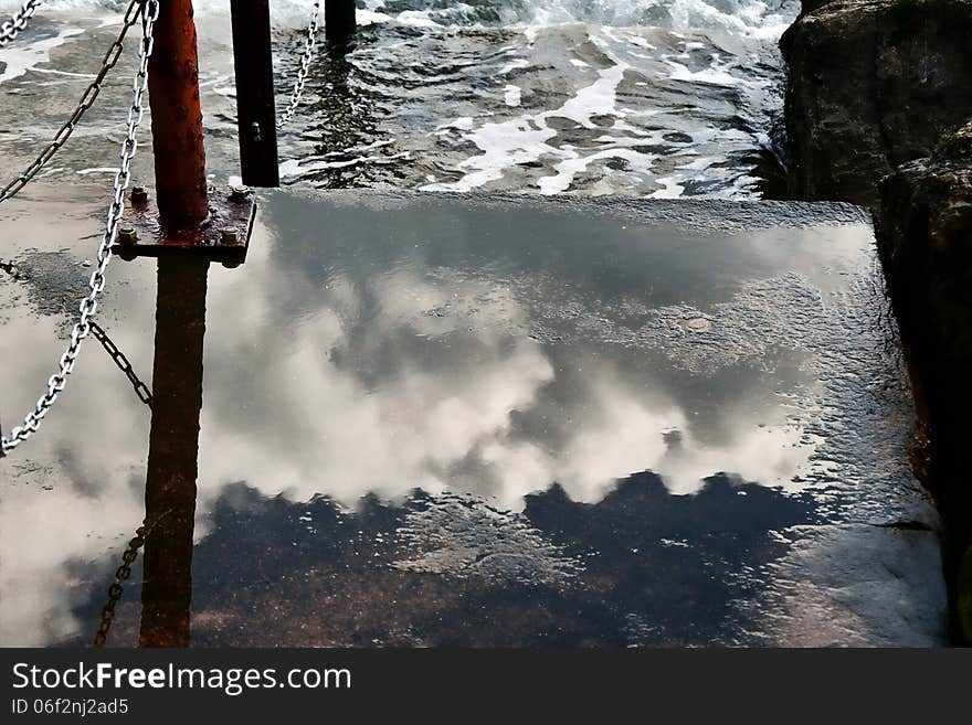 Clouds reflected in the wet steps down to the sea at Lyme Regis, Dorset. Clouds reflected in the wet steps down to the sea at Lyme Regis, Dorset