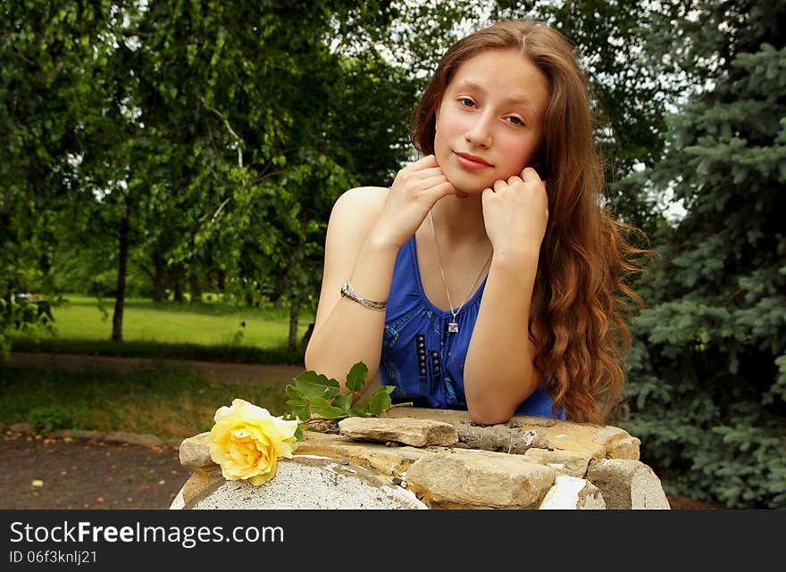 Pretty girl holding a yellow rose