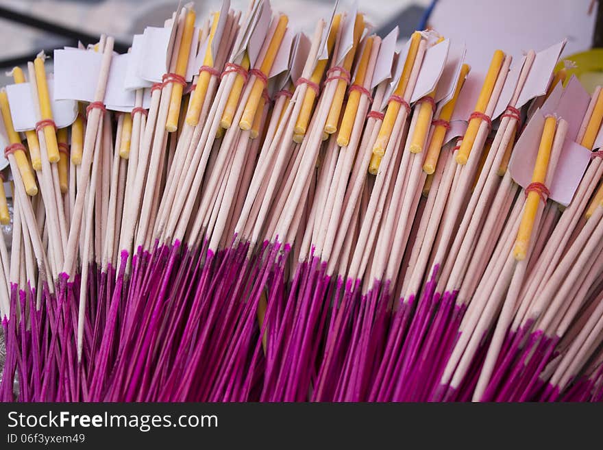 Incense sticks with candle and gold sheet in paper cover