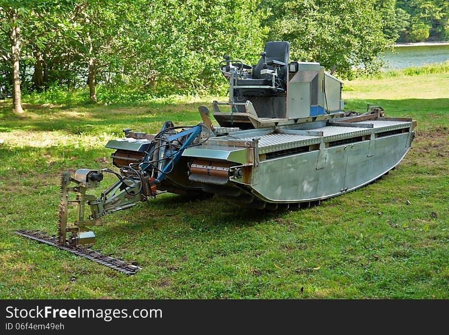 Amphibious vehicle with cutter trimmer for work in rivers and lakes